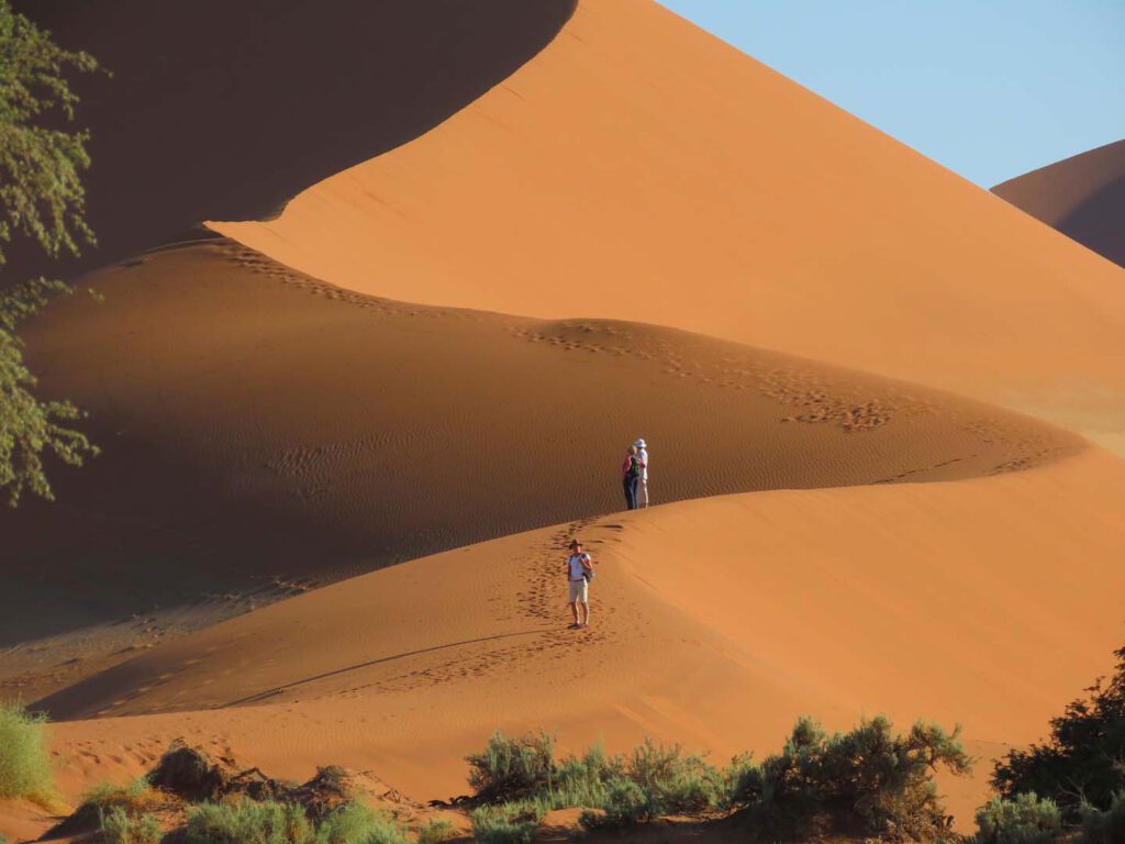 people climbing sand dunes at Sossusvlei